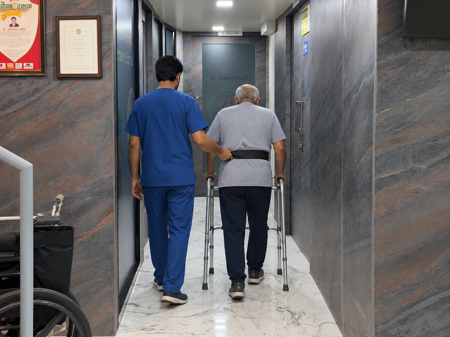 A patient walking with a physiotherapist during early recovery after knee replacement